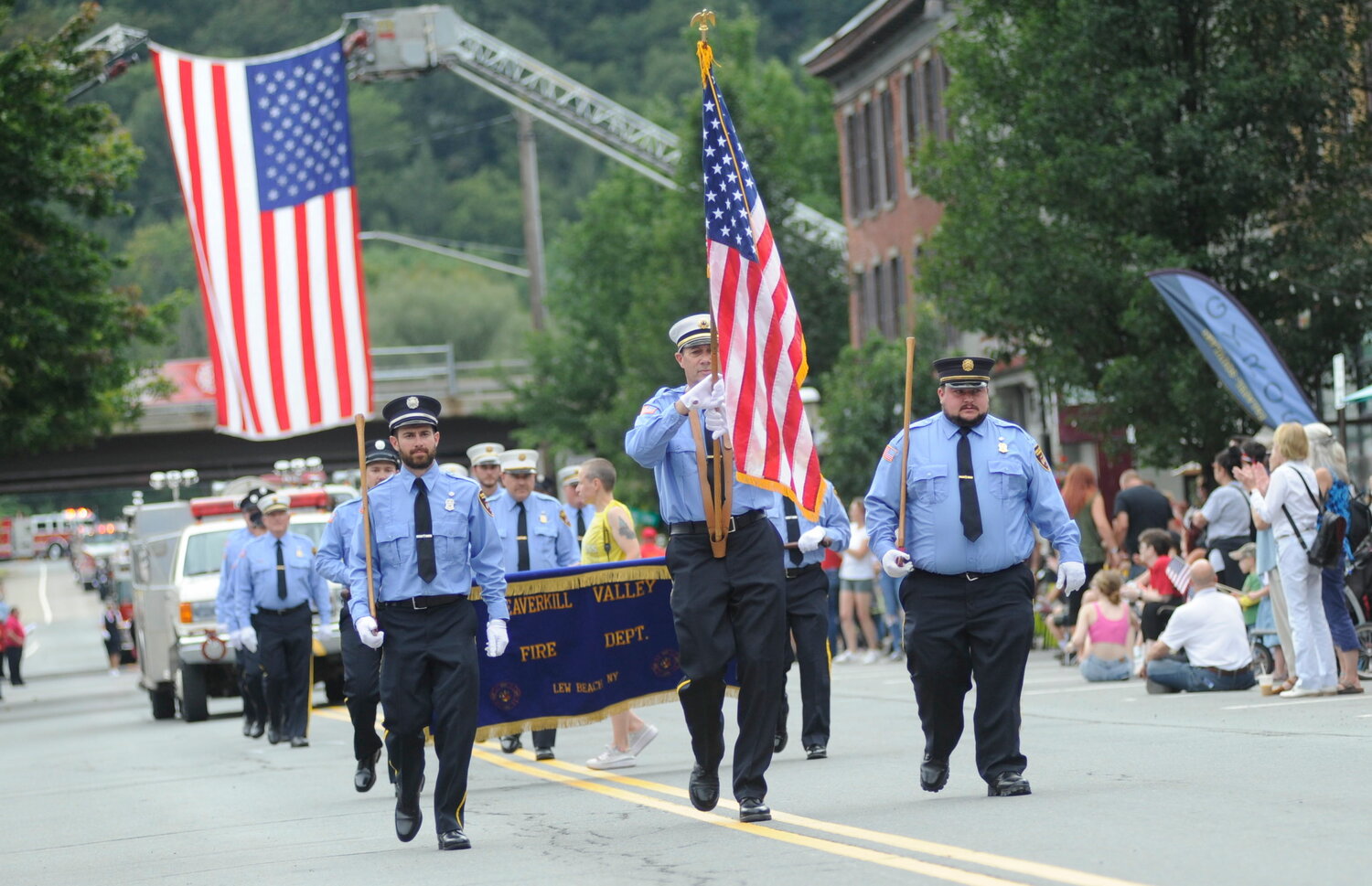 Members of the Beaverkill Valley Fire Department lead their contingent down Roscoe’s main street moments after passing beneath the giant American flag suspended over the roadway...